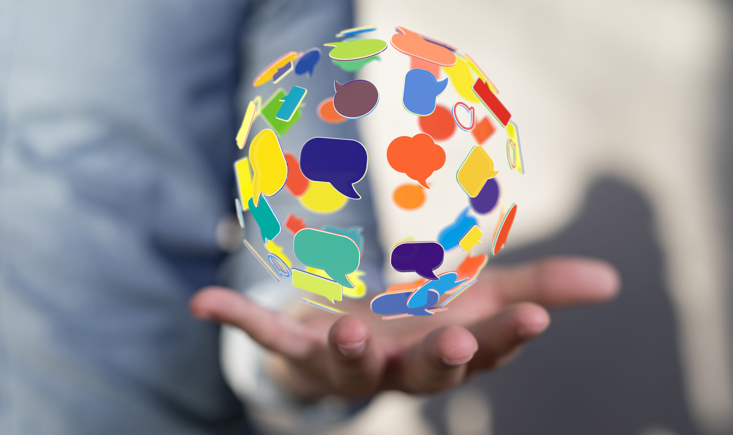 outstretched hand, palm up, holding illustrated orb made of chat bubbles