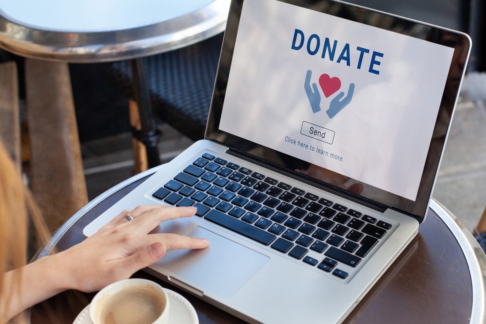 A person at a laptop with a Donate page on the screen